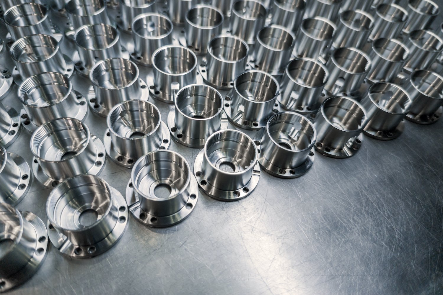 shiny-metal-aerospace-parts-after-cnc-machining-on-steel-surface-with-selective-focus-industrial-background
